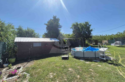 Garden with a wooden cottage in a new guard for sale